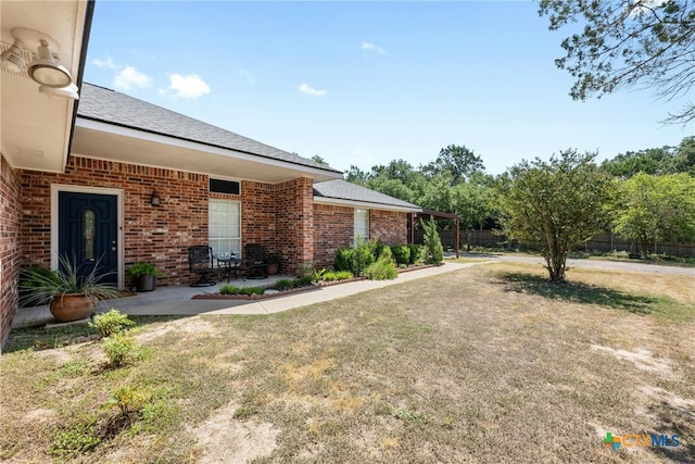 exterior space featuring a patio and a front lawn