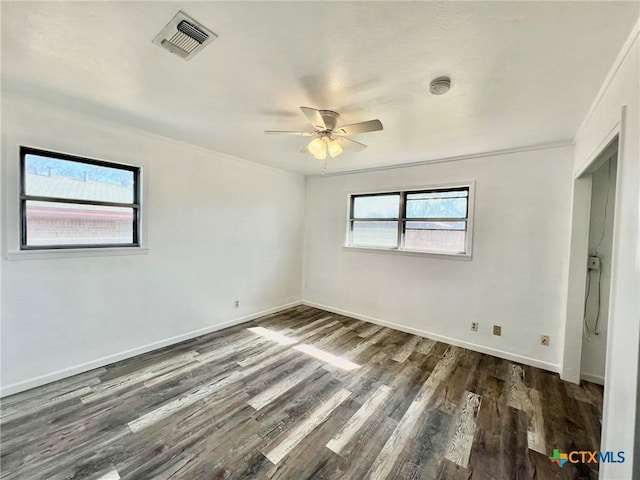 unfurnished room featuring visible vents, ceiling fan, baseboards, and wood finished floors