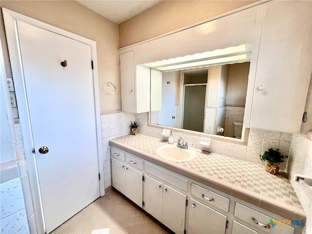 full bath featuring a shower stall, toilet, and vanity