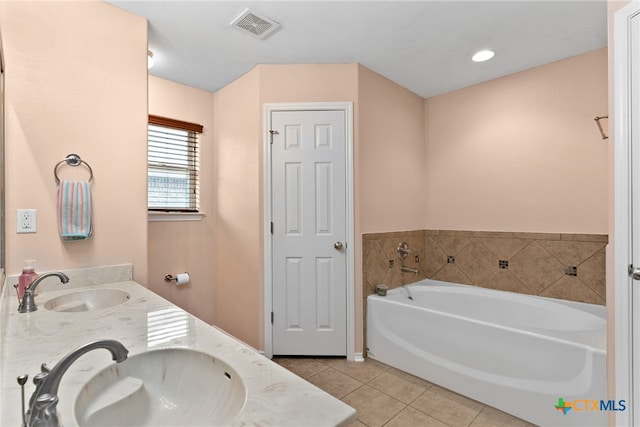 full bathroom with double vanity, a sink, visible vents, and tile patterned floors