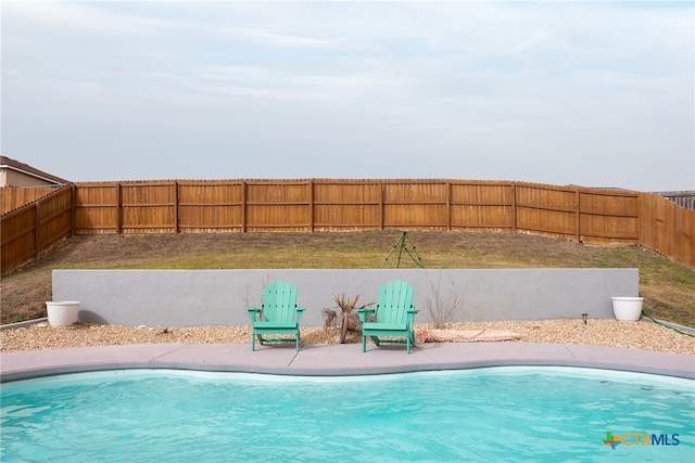 view of swimming pool with a fenced backyard and a fenced in pool