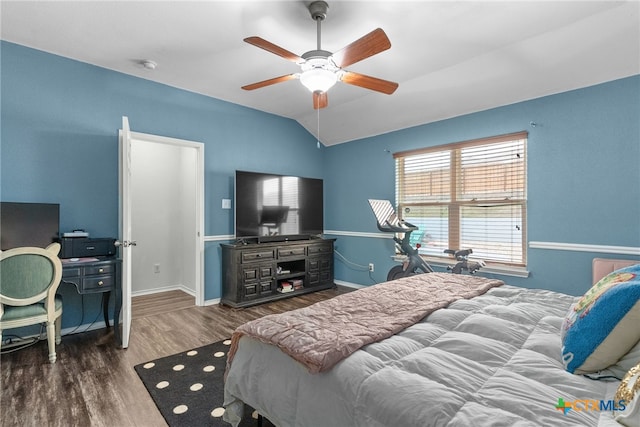 bedroom with a ceiling fan, baseboards, vaulted ceiling, and wood finished floors