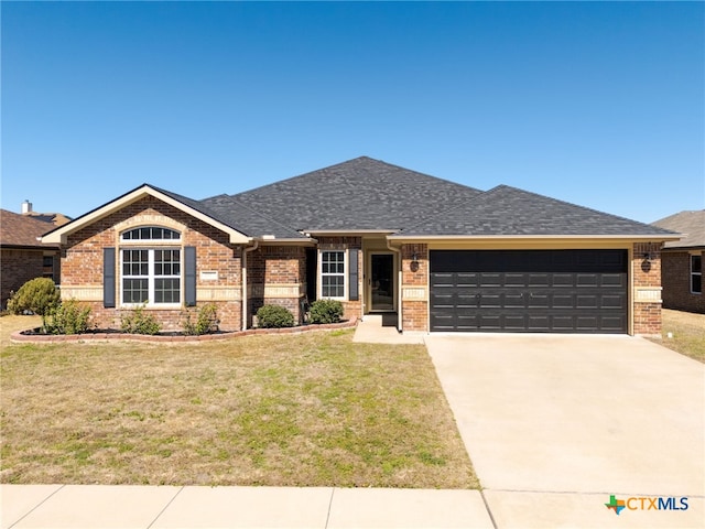 ranch-style house with a garage, brick siding, a shingled roof, concrete driveway, and a front yard