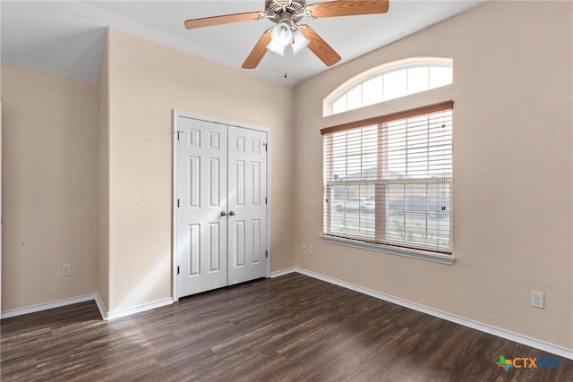 unfurnished bedroom featuring a closet, wood finished floors, a ceiling fan, and baseboards