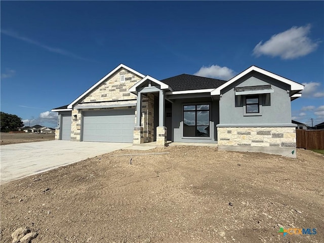 4018 Prairie Dr, Nolanville, TX 76559 - view of front of house featuring stone siding, an attached garage, driveway, and stucco siding