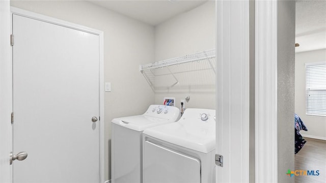 9741 Sandy Ridge Way, San Antonio, TX 78239 - laundry area featuring independent washer and dryer and wood finished floors
