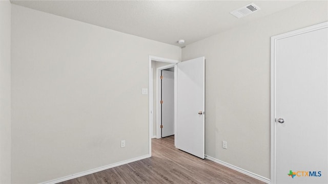 9741 Sandy Ridge Way, San Antonio, TX 78239 - unfurnished bedroom with wood finished floors and baseboards