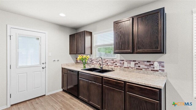 9741 Sandy Ridge Way, San Antonio, TX 78239 - kitchen with black dishwasher, dark brown cabinetry, tasteful backsplash, light wood finished floors, and light countertops