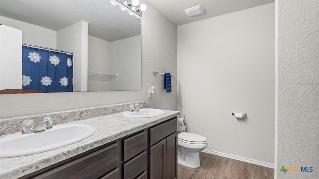9741 Sandy Ridge Way, San Antonio, TX 78239 - full bathroom with double vanity, wood finished floors, and curtained shower