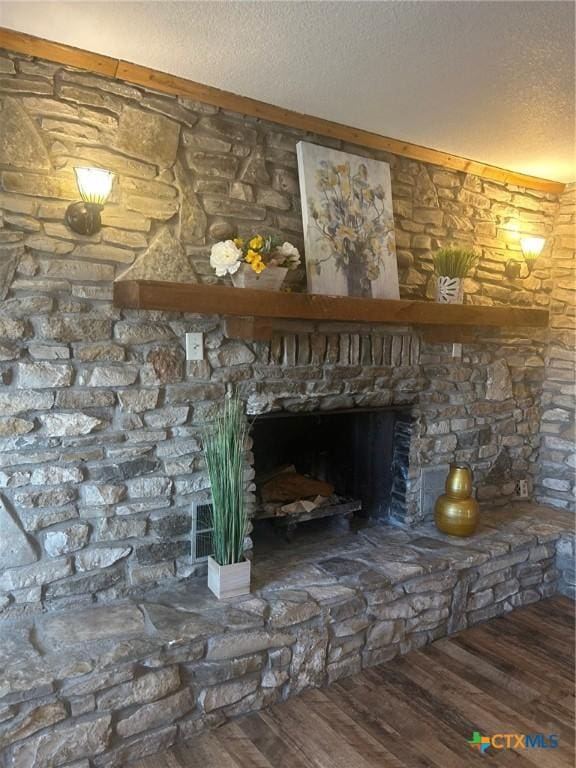 room details featuring a textured ceiling, a fireplace, and hardwood / wood-style floors