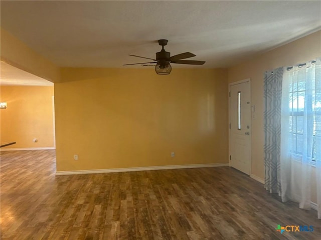 spare room with hardwood / wood-style flooring and ceiling fan