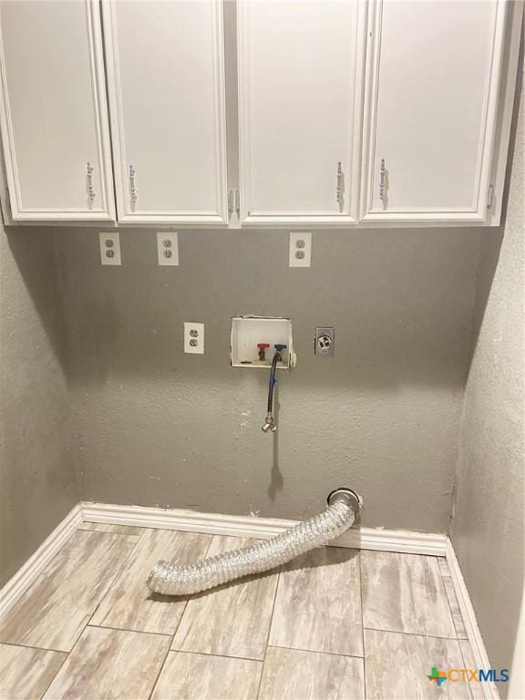 clothes washing area featuring washer hookup, cabinets, and electric dryer hookup