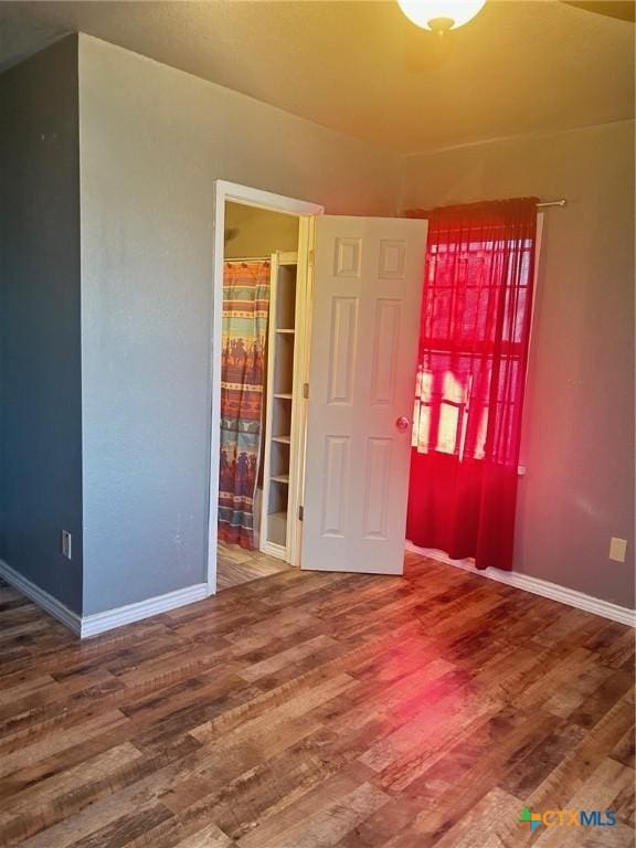 empty room with hardwood / wood-style flooring