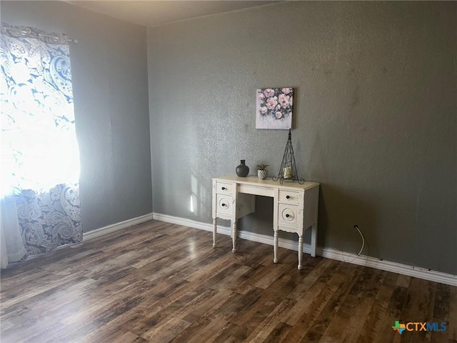 unfurnished office with dark wood-type flooring