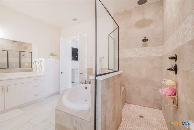 bathroom featuring vanity and shower with separate bathtub