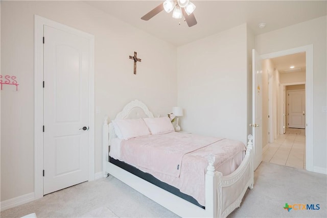 bedroom featuring light carpet and ceiling fan