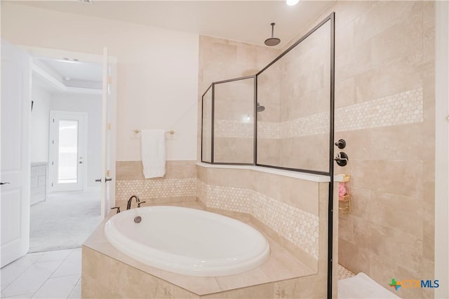 bathroom featuring plus walk in shower and tile patterned floors