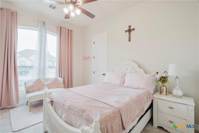 bedroom featuring ceiling fan and light carpet