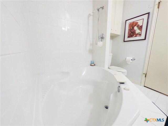 bathroom with toilet and tile patterned flooring