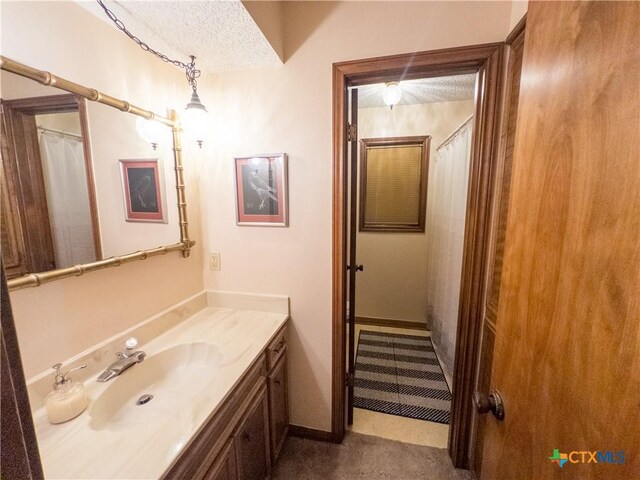 bathroom with a textured ceiling and vanity