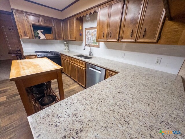kitchen with dishwasher, a sink, open shelves, range with gas cooktop, and light stone countertops