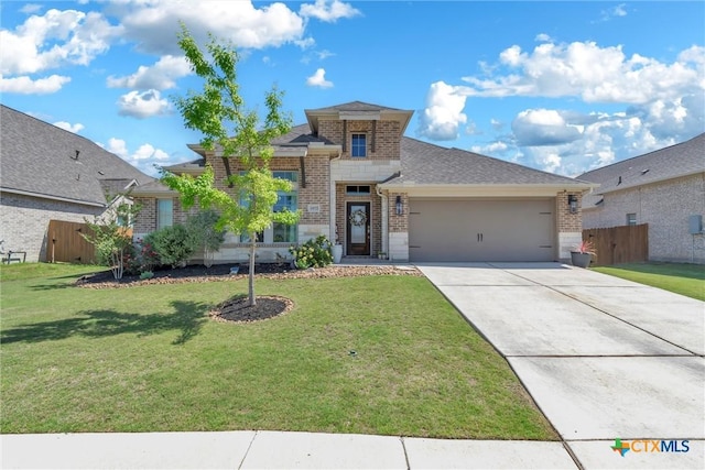 view of front of house featuring a front yard, a garage, fence, concrete driveway, and brick siding