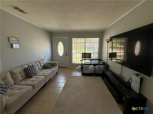1403 Little St, Copperas Cove, TX 76522 - living area featuring tile patterned flooring, a textured ceiling, and crown molding