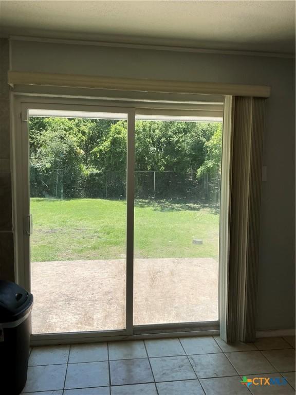 1403 Little St, Copperas Cove, TX 76522 - doorway to outside with healthy amount of natural light and light tile patterned floors