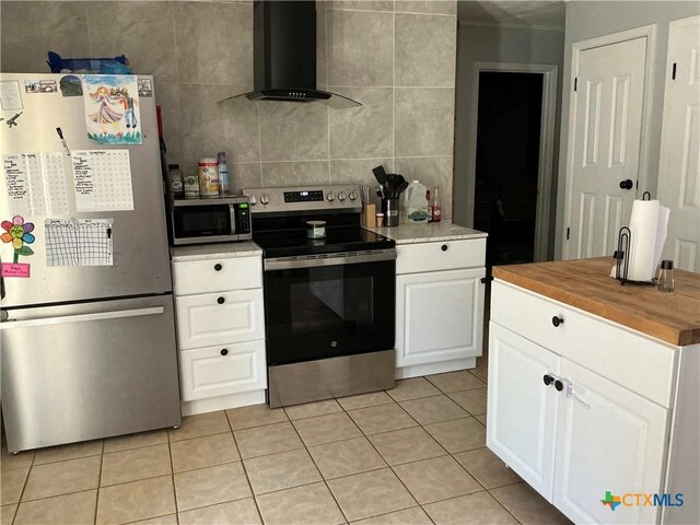 1403 Little St, Copperas Cove, TX 76522 - kitchen featuring stainless steel appliances, extractor fan, wood counters, light tile patterned floors, and white cabinetry