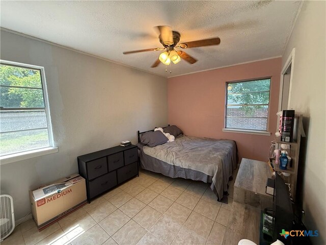 1403 Little St, Copperas Cove, TX 76522 - bedroom featuring light tile patterned floors, a textured ceiling, ceiling fan, and ornamental molding