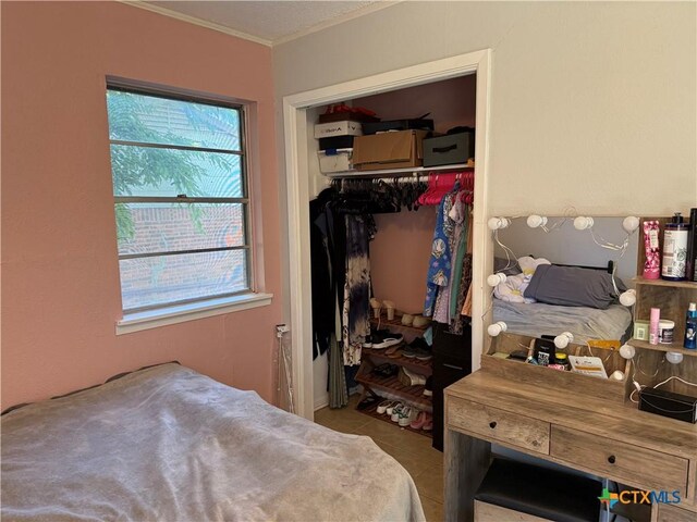 1403 Little St, Copperas Cove, TX 76522 - bedroom featuring a closet, ornamental molding, and tile patterned flooring