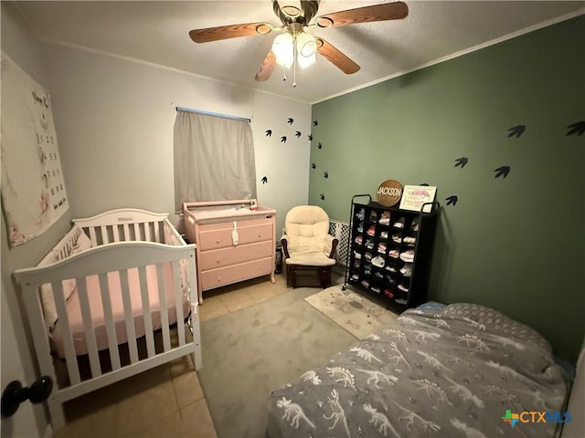 1403 Little St, Copperas Cove, TX 76522 - bedroom featuring tile patterned floors, ceiling fan, crown molding, carpet, and a nursery area