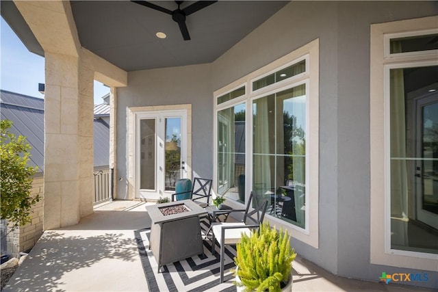 view of patio with a ceiling fan and a fire pit