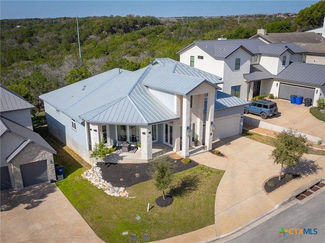 drone / aerial view with a residential view and a view of trees