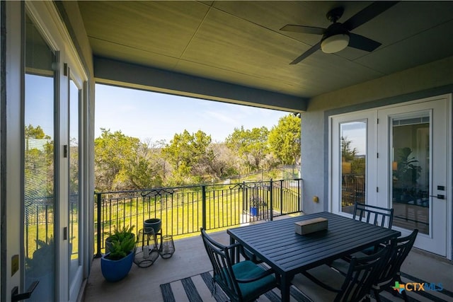 balcony featuring a sunroom and ceiling fan