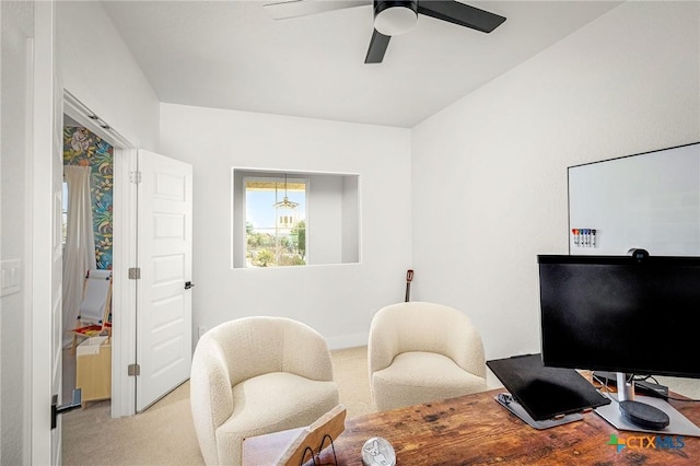 home office featuring a ceiling fan and light colored carpet