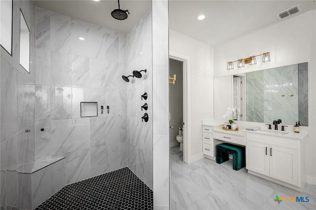 full bathroom with marble finish floor, visible vents, toilet, vanity, and tiled shower