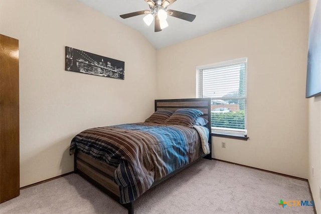 carpeted bedroom featuring lofted ceiling and ceiling fan