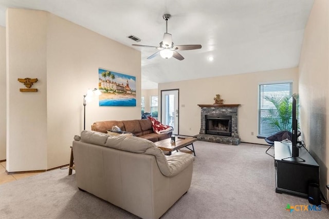 carpeted living room featuring ceiling fan, a fireplace, and vaulted ceiling