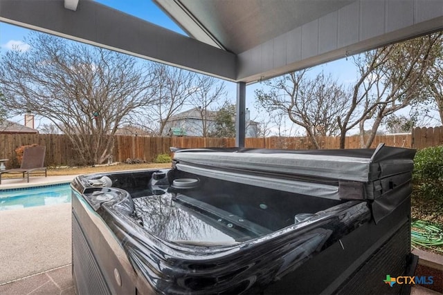 exterior space featuring a swimming pool with hot tub