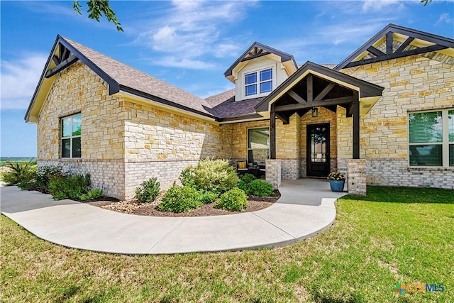 8508 Mount Nebo Cir, Belton, TX 76513 - view of front of house with stone siding, a front yard, and roof with shingles