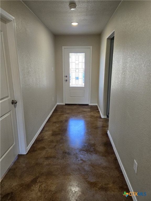 doorway featuring a textured ceiling