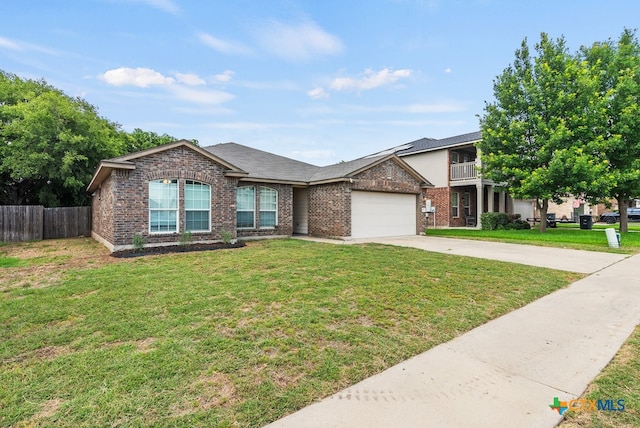 view of front of property with a garage and a front lawn