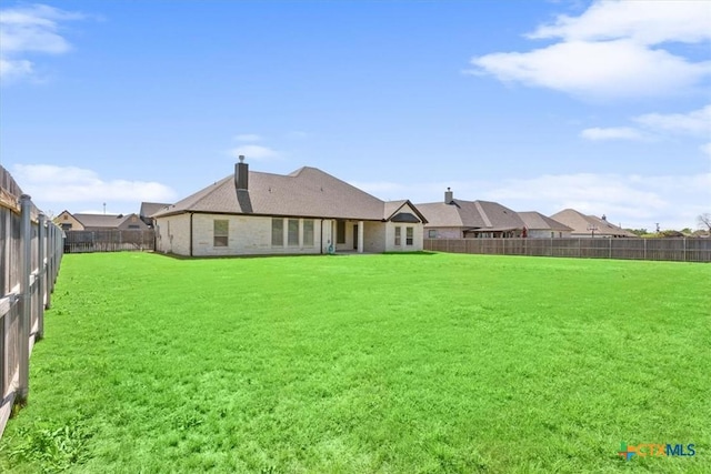 124 Cumberland Dr, Belton, TX 76513 - rear view of house featuring a yard, a fenced backyard, and a chimney