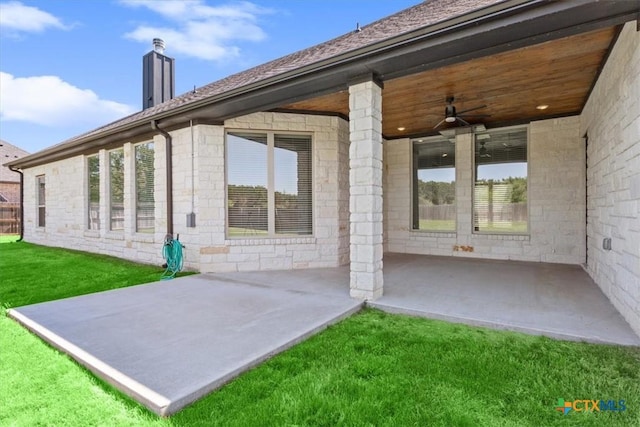 124 Cumberland Dr, Belton, TX 76513 - back of house featuring a patio, a chimney, stone siding, and a lawn