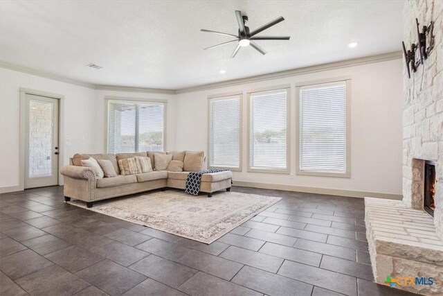 124 Cumberland Dr, Belton, TX 76513 - living room with crown molding, ceiling fan, a fireplace, and visible vents