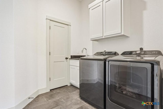 124 Cumberland Dr, Belton, TX 76513 - laundry room featuring a sink, washing machine and clothes dryer, and cabinet space