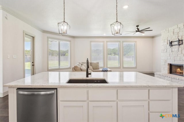 124 Cumberland Dr, Belton, TX 76513 - kitchen with light stone countertops, open floor plan, dishwasher, and a sink
