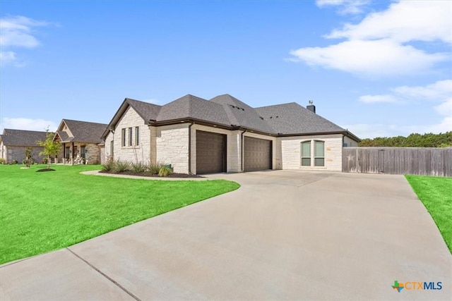 124 Cumberland Dr, Belton, TX 76513 - french country inspired facade with stone siding, a garage, fence, concrete driveway, and a front lawn