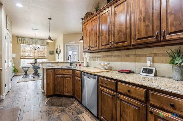 kitchen with dark wood-style floors, a peninsula, a sink, decorative backsplash, and dishwasher